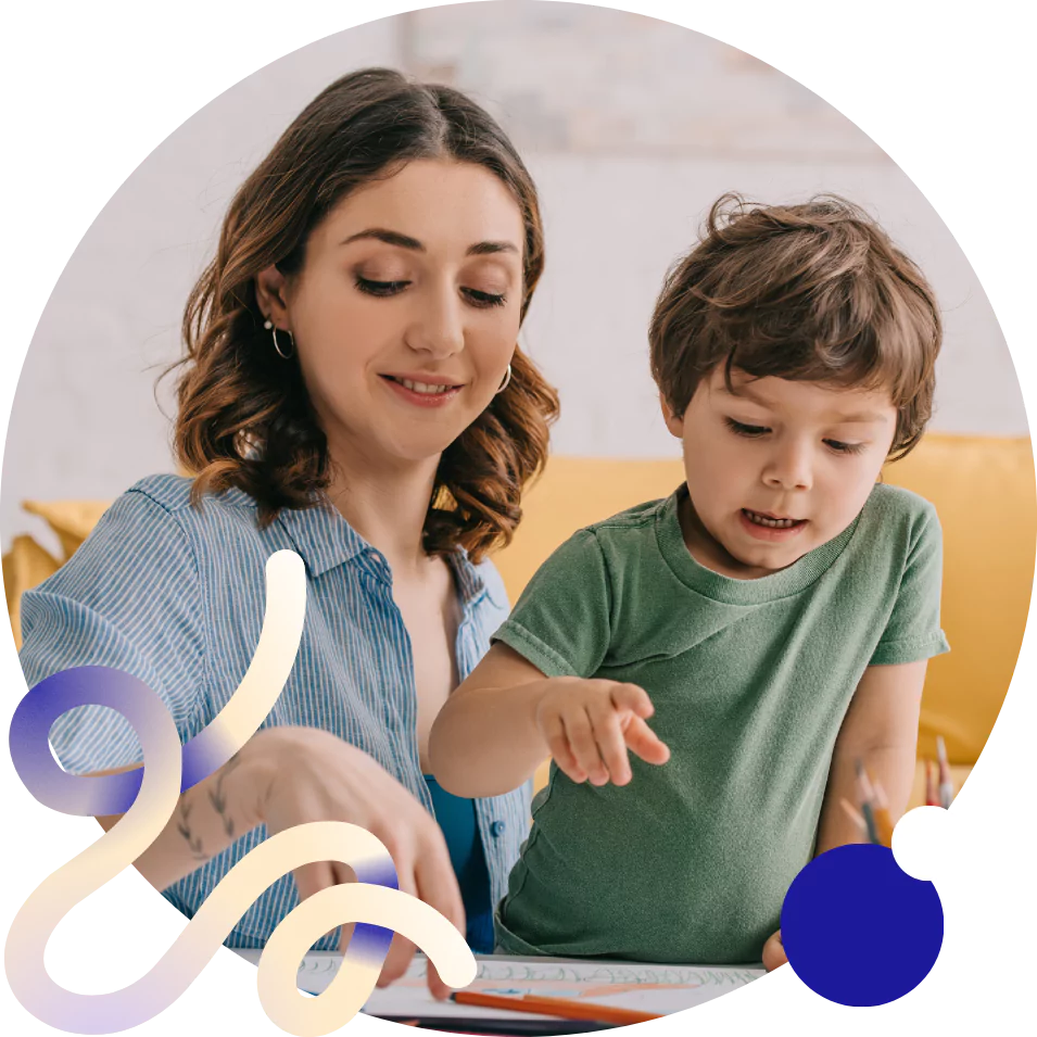 In a Support and Therapy setting, a child and his mum look at a drawing