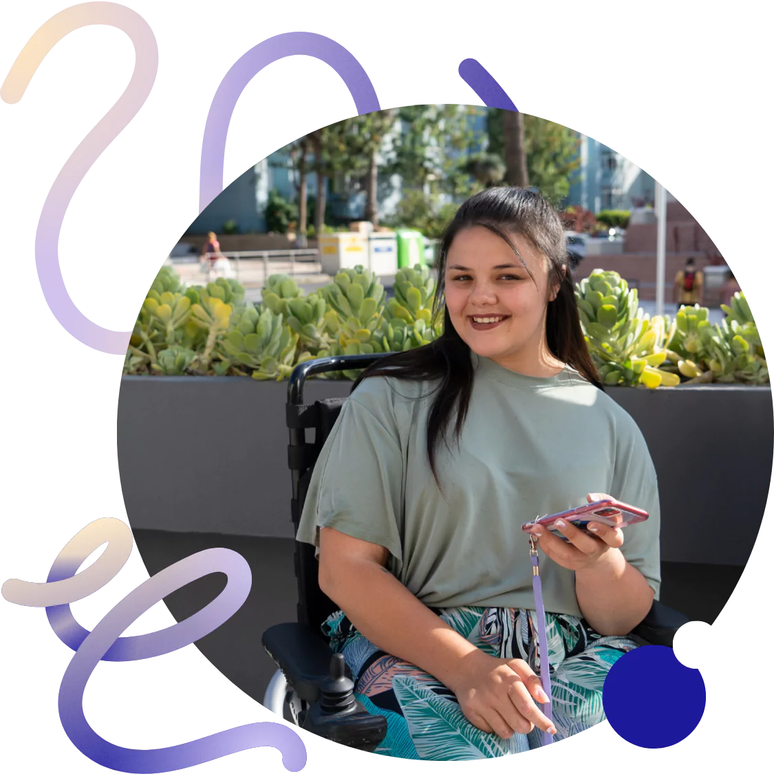 A disabled woman sitting in her wheelchair smiling